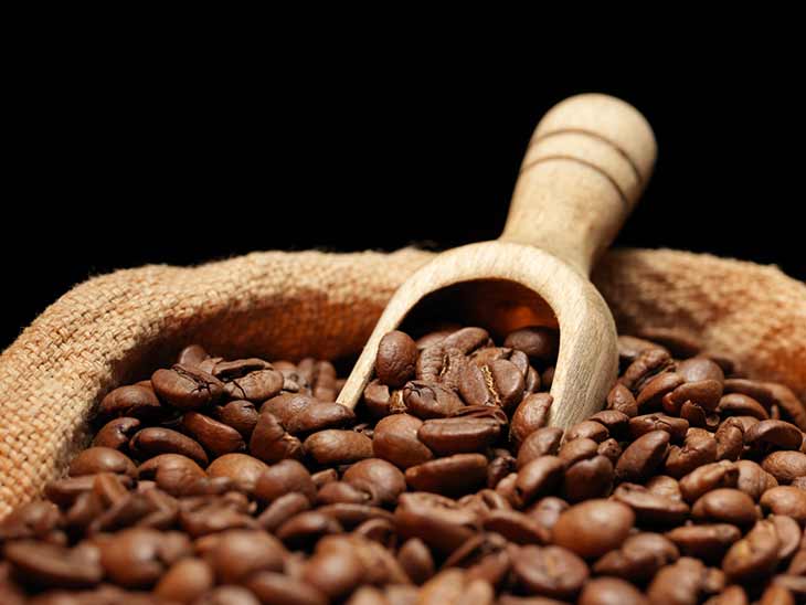 scoop of coffee beans in a bag