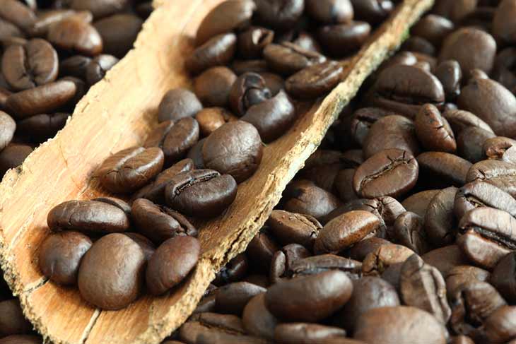 coffee beans close up wooden scoop
