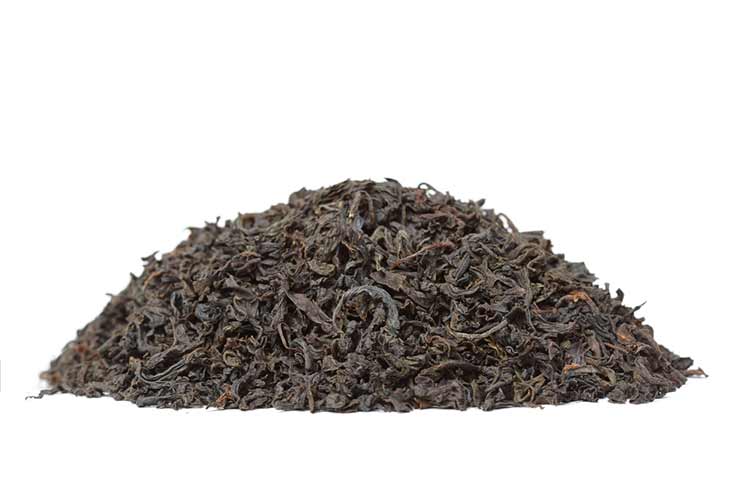 a pile of black tea leaves